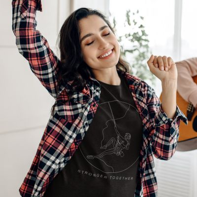 Stronger Together Womans Rock Climbing Black Relax Minimal Outdoor Tshirt Apparel Design of a Girl with dark hair dancing while wearing a red and black flannel shirt while a man plays guitar